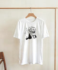 Vit t-shirt med Trollface motiv hängande på en klädställning
