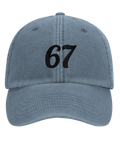 Svart kursiv text "67" på en urtvättad blå dad cap, framifrån.