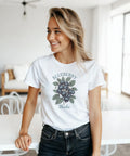 Leende kvinna bär vit t-shirt med lekfullt och naturinspirerat blåbärsmotiv