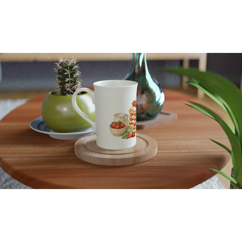 Vit mugg med retroinspirerat bakverksmotiv placerad på ett soffbord