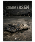 En sliten arbetshandske ligger på ett smutsigt betonggolv med texten KOMMERSEN i bakgrunden på en mörk vägg.