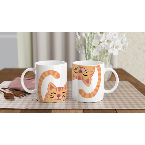 Söt mugg med orange katter