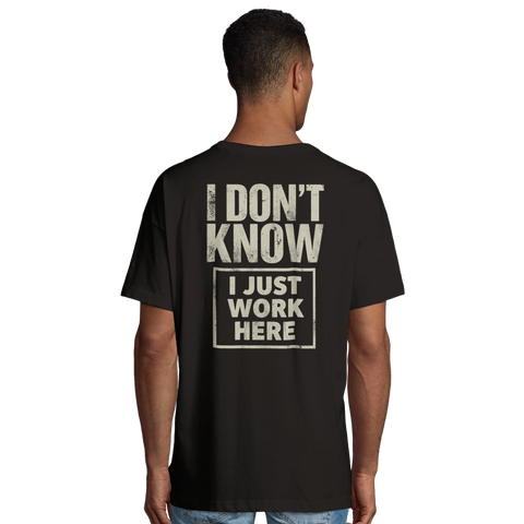 Man bär svart oversized t-shirt med stort ryggtryck och ironisk text