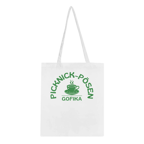 Vit tygkasse med grönt picknickmotiv och texten Picknick-Påsen Gofika