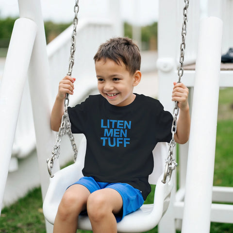 Blå text "LITEN MEN TUFF" på svart barn-t-shirt med rund hals.
