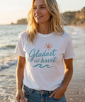 Kvinna på strand bär somrig t-shirt med texten Gladast vid havet