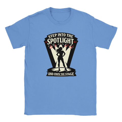 Svart siluett av kvinna i spotlight med texten "STEP INTO THE SPOTLIGHT AND OWN THE STAGE" på ljusblå t-shirt.