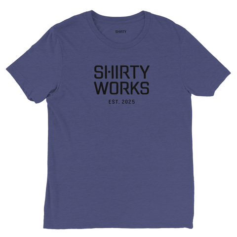 Shirty Works EST. 2025" svart text på mörkblå triblend t-shirt.