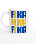 Vit kaffemugg med blå och gul text FIKA FIKA FIKA i grafisk svensk design