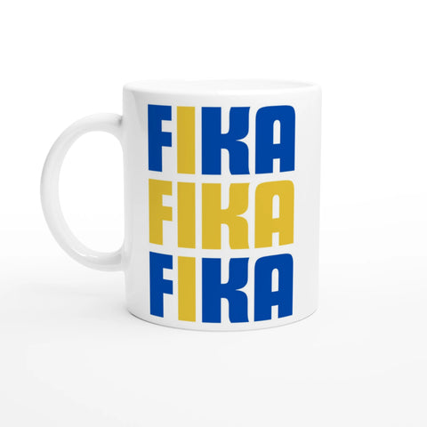 Vit kaffemugg med blå och gul text FIKA FIKA FIKA i grafisk svensk design