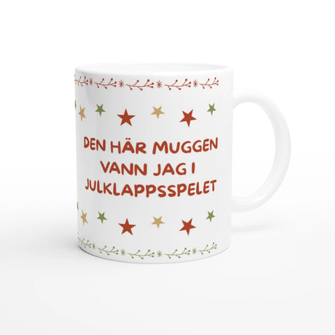 vit julmugg med röd text den här muggen vann jag i julklappsspelet och stjärnor