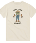 Beige t-shirt med tecknad groda som håller två små hästar och texten Hold Your Horses