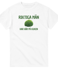 Rolig t-shirt med texten Riktiga män har hår på kuken och en bild på en grön buske. 